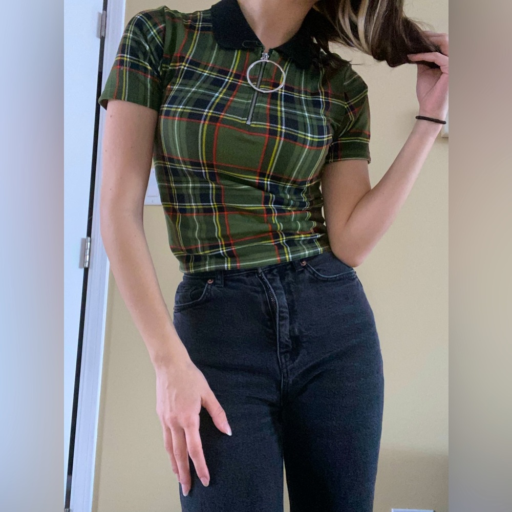 Green top with black collar and statement zipper